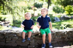 vibrant image of two little boys sitting on a rock wall in Newton MA